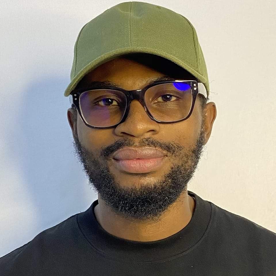 Headshot of Vincent Iroleh wearing glasses and a green cap